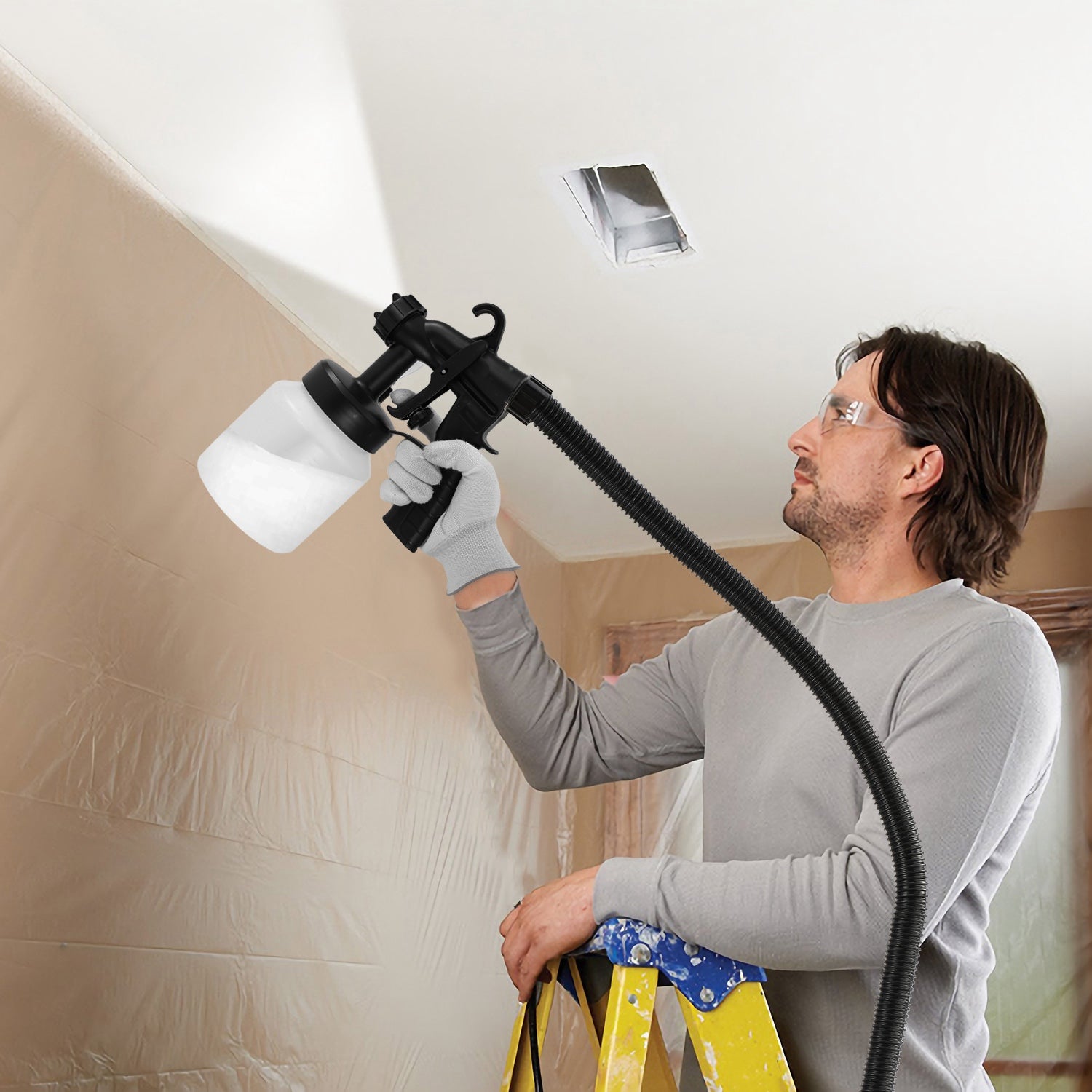 HVLP sprayer in use on wooden furniture